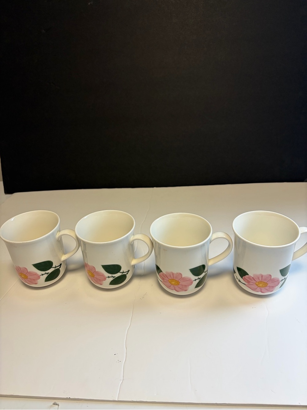 A Set Of 4 Villeroy & Boch Wild Rose Mugs With Glower And Leaf Motif